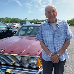 70-year GRAR Member Gene Cassata standing next to his 1981 Chevy Malibu Classic